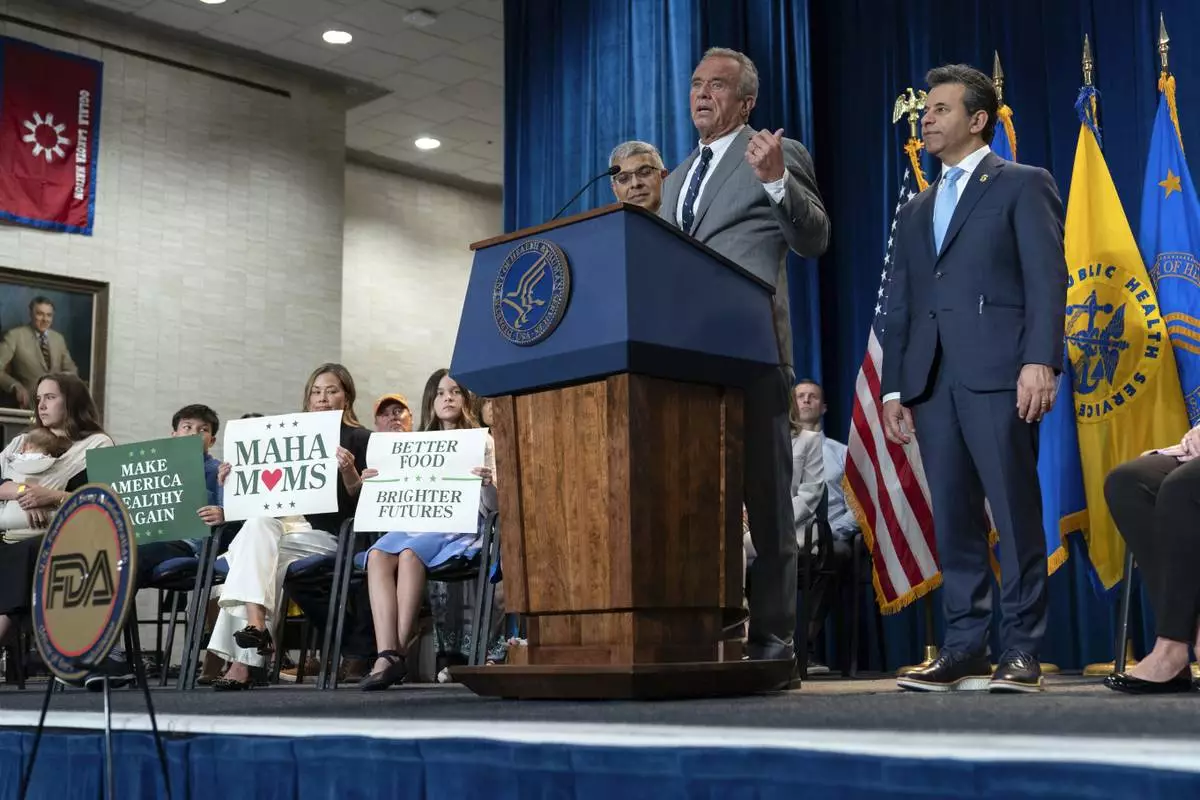 Health and Human Services Secretary Robert F. Kennedy Jr. flanked by Director of the National Institutes of Health Jay Bhattacharya, left, and Food and Drug Administration (FDA) commissioner Marty Makary, right, speaks during a news conference on the FDA's intent to phase out the use of petroleum-based synthetic dyes in the nation's food supply at the Hubert Humphrey Building Auditorium in Washington, Tuesday, April 22, 2025. (AP Photo/Jose Luis Magana)