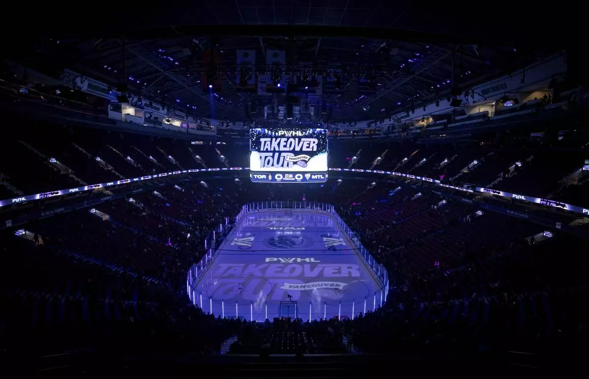FILE - Fans gather to watch the Montreal Victoire and the Toronto Sceptres warm up before a PWHL hockey game in Vancouver, Wednesday, Jan. 8, 2025. (Ethan Cairns/The Canadian Press via AP, File)