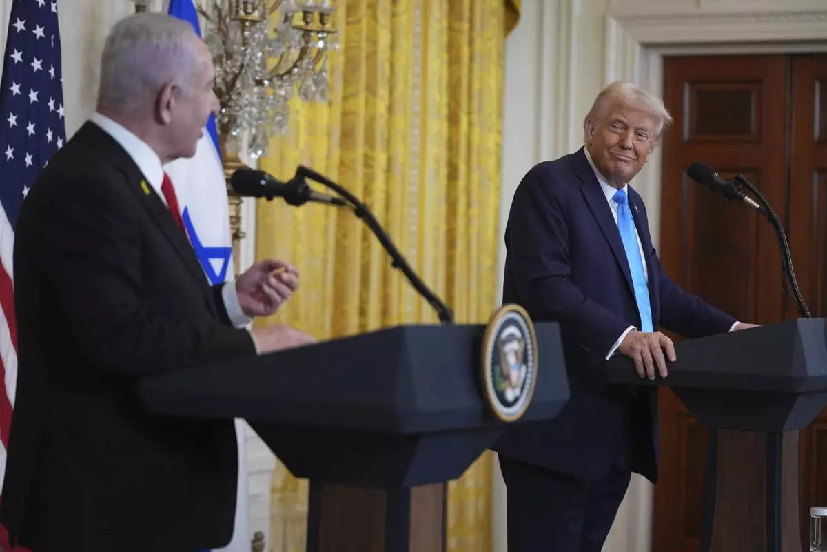 FILE - President Donald Trump listens as Israel's Prime Minister Benjamin Netanyahu speaks during a news conference in the East Room of the White House, Feb. 4, 2025, in Washington. (AP Photo/Evan Vucci, File)
