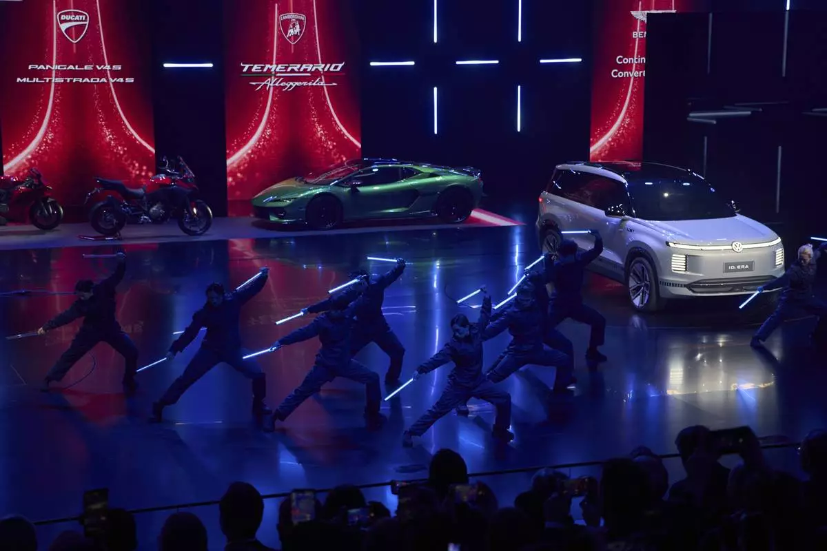 Performers take part in the Volkswagen Group media night ahead of the Auto Show in Shanghai, Tuesday, April 22, 2025. (AP Photo/Ng Han Guan)