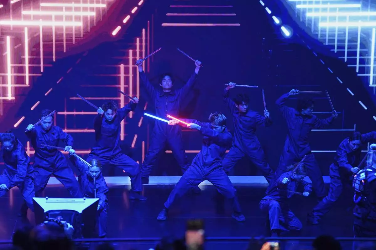 Performers take part in the Volkswagen Group media night ahead of the Auto Show in Shanghai, Tuesday, April 22, 2025. (AP Photo/Ng Han Guan)