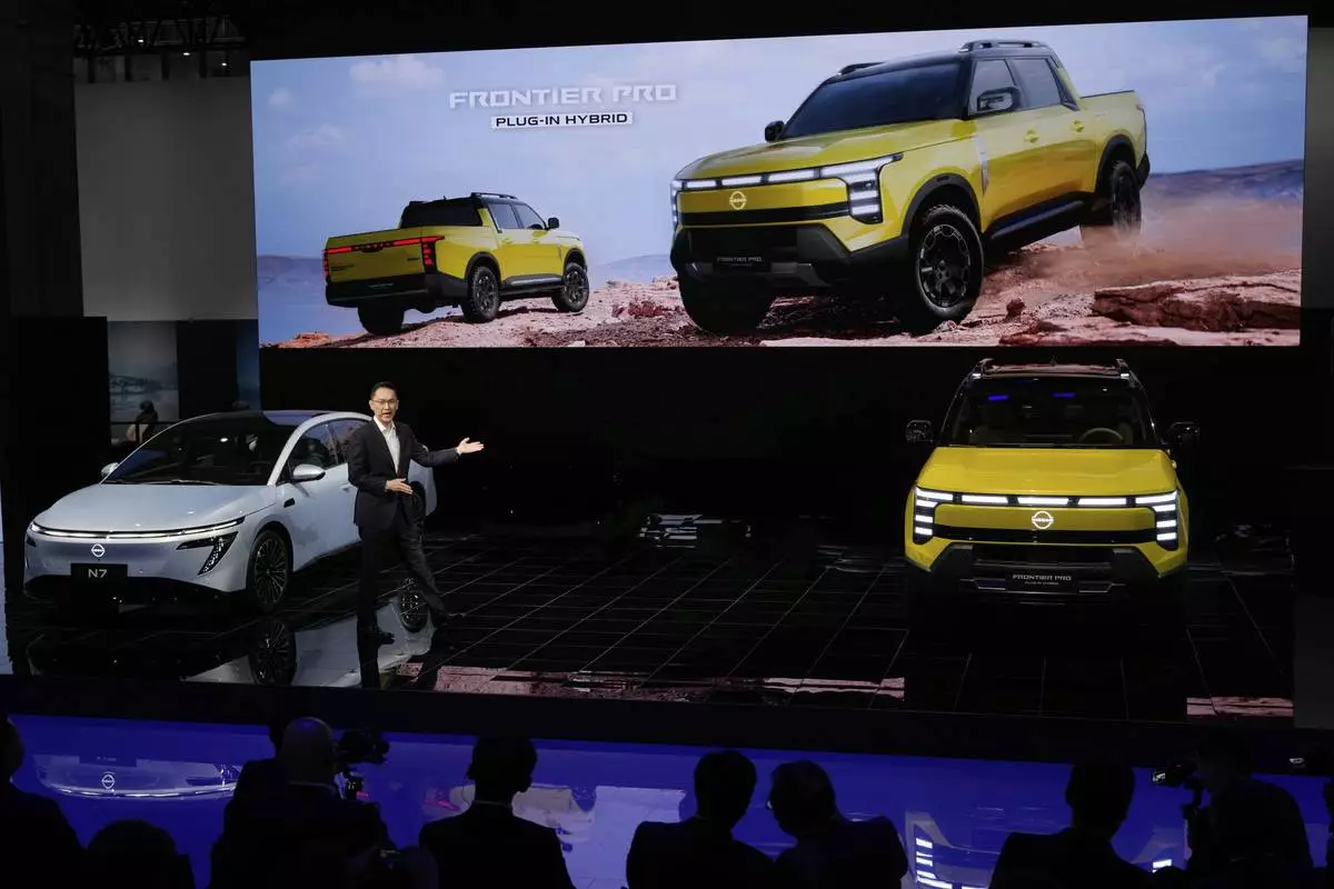 An executive from Nissan unveiled the Frontier Pro, a plug-in hybrid, during the Shanghai auto show on Wednesday, April 23, 2025. (AP Photo/Ng Han Guan)