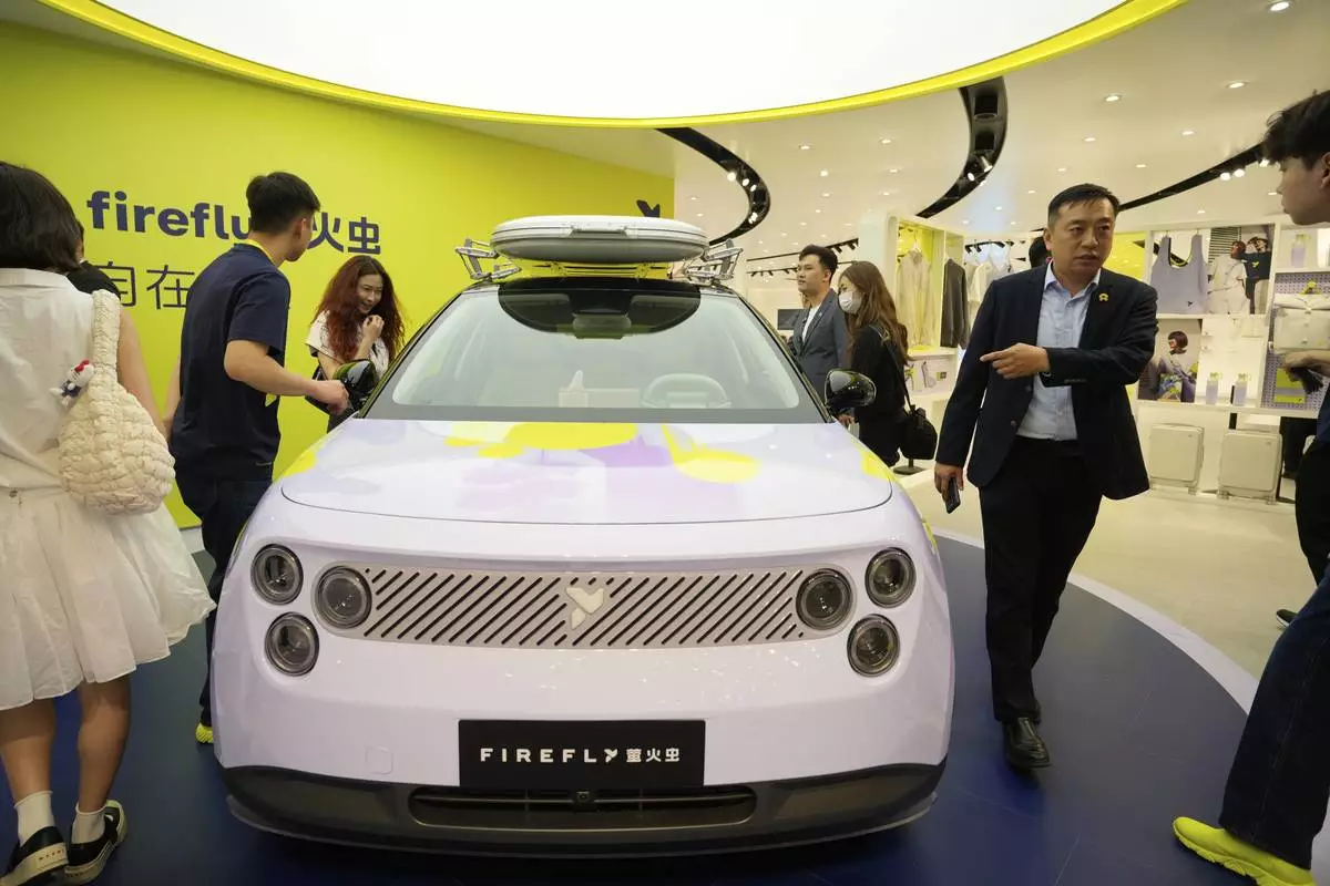 Visitors look at the new Firefly model from Chinese automaker Nio during the Shanghai auto show on Wednesday, April 23, 2025. (AP Photo/Ng Han Guan)