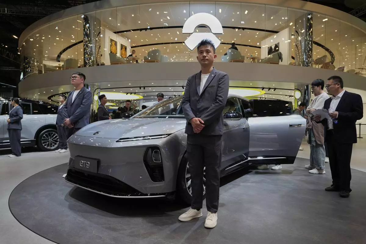 Staff from Chinese automaker Nio waits for visitors at their booth during the Shanghai auto show on Wednesday, April 23, 2025. (AP Photo/Ng Han Guan)