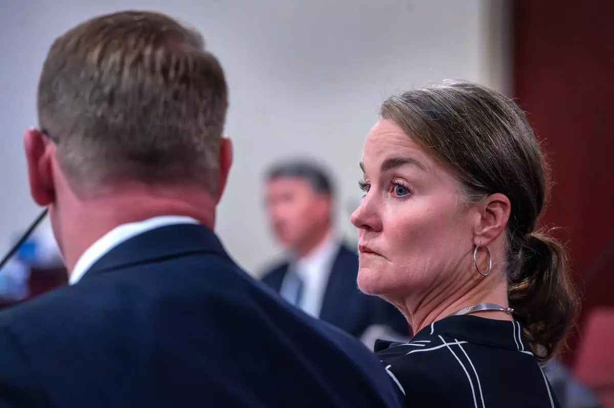 Julia Peters, center, representing the estate of actor Gene Hackman and his wife Betsy Arakawa Hackman, sits with her attorneys regarding a case that involves the release of any public records in First District Court, in Santa Fe, N.M., Monday, March 31, 2025. (Eddie Moore/The Albuquerque Journal via AP)