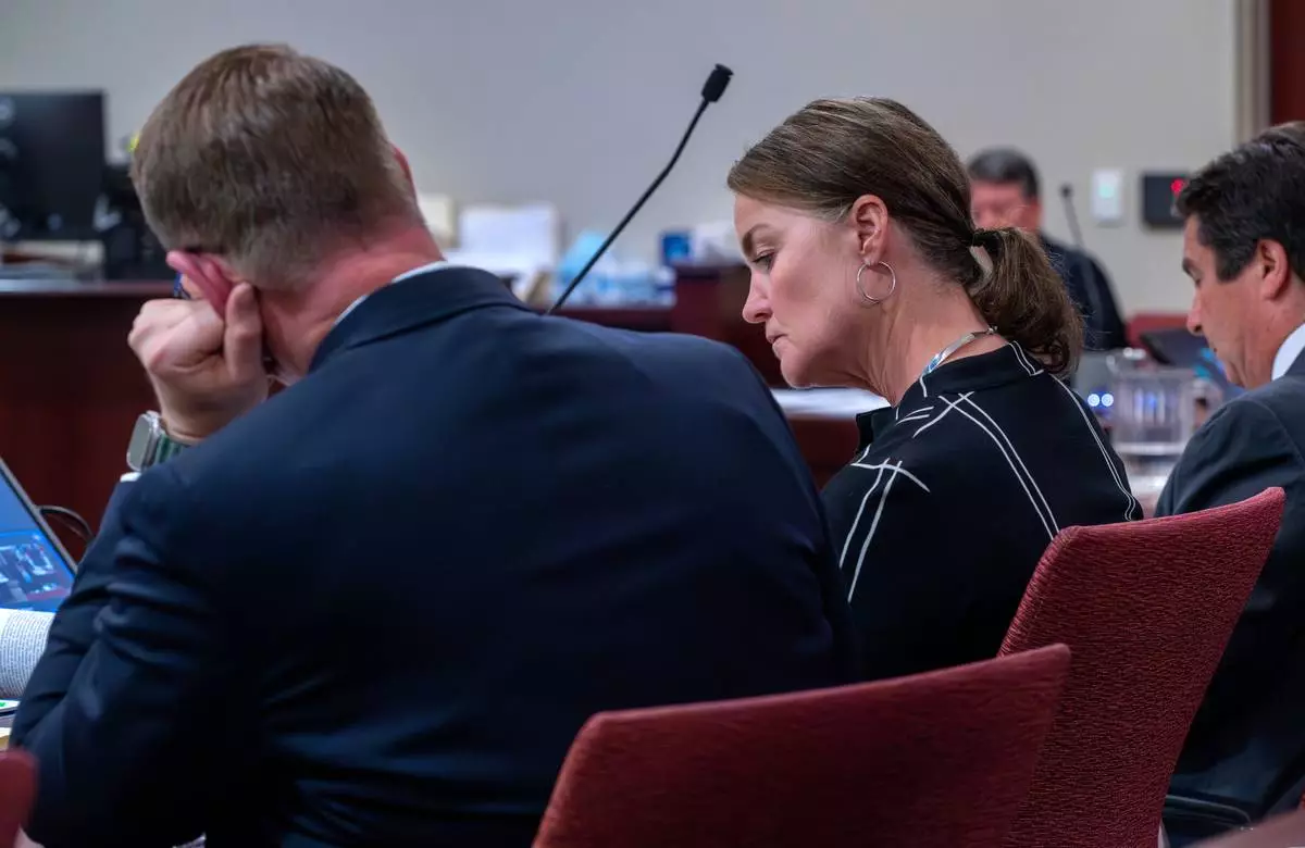 Julia Peters, center, representing the estate of actor Gene Hackman and his wife Betsy Arakawa Hackman, sits in First District Court with her attorneys during arguments for an injunction to prevent the release of photos and other evidence related to the death of the Hackmans last month, in Santa Fe, N.M., Monday, March 31, 2025. (Eddie Moore/The Albuquerque Journal via AP)