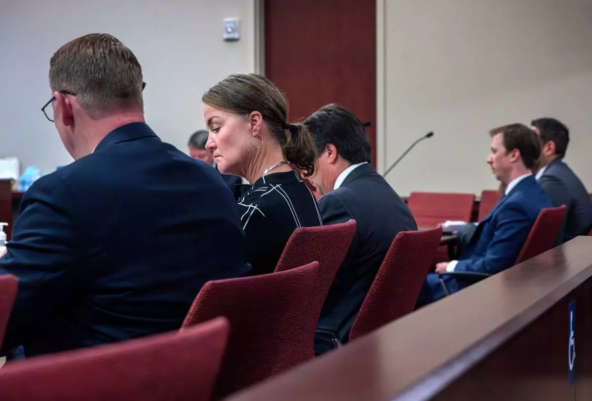 Julia Peters, center, representing the estate of actor Gene Hackman and his wife Betsy Arakawa Hackman, sits in First District Court with her attorneys during arguments for an injunction to prevent the release of photos and other evidence related to the death of the Hackmans last month, in Santa Fe, N.M., Monday, March 31, 2025. (Eddie Moore/The Albuquerque Journal via AP)