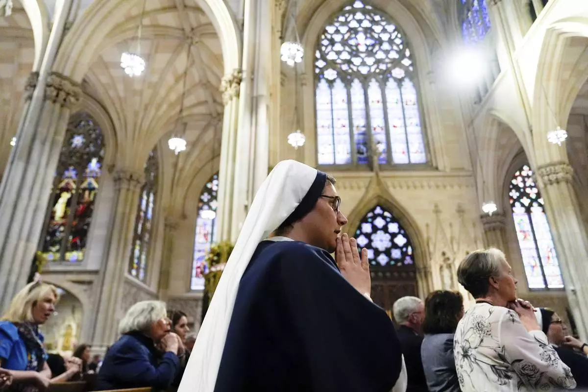 Parishioners pray during a mass for Pope Francis at St. Patrick's Cathedral, Tuesday, April 22, 2025, in New York. (AP Photo/Julia Demaree Nikhinson)