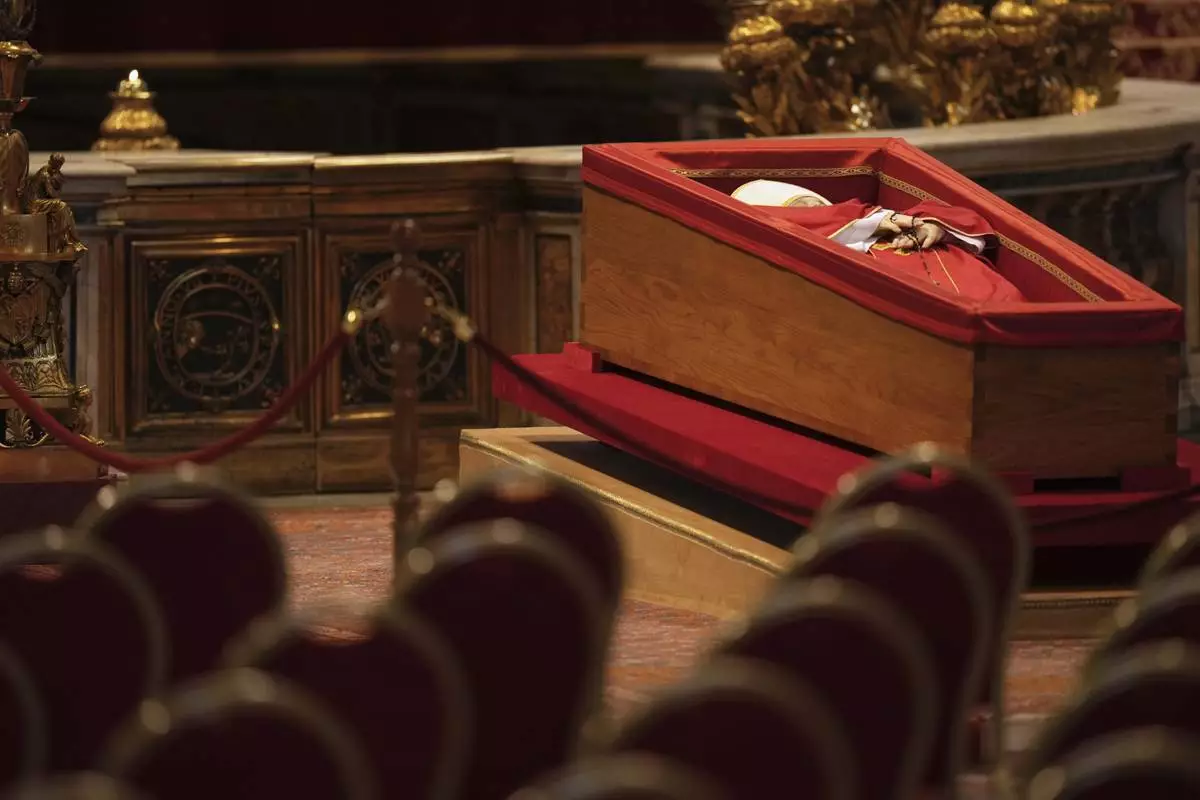 The body of Pope Francis, who will lie in state for three days, sits in St. Peter's Basilica before the doors are open to the public, at the Vatican, Wednesday, April 23, 2025. (AP Photo/Francisco Seco)