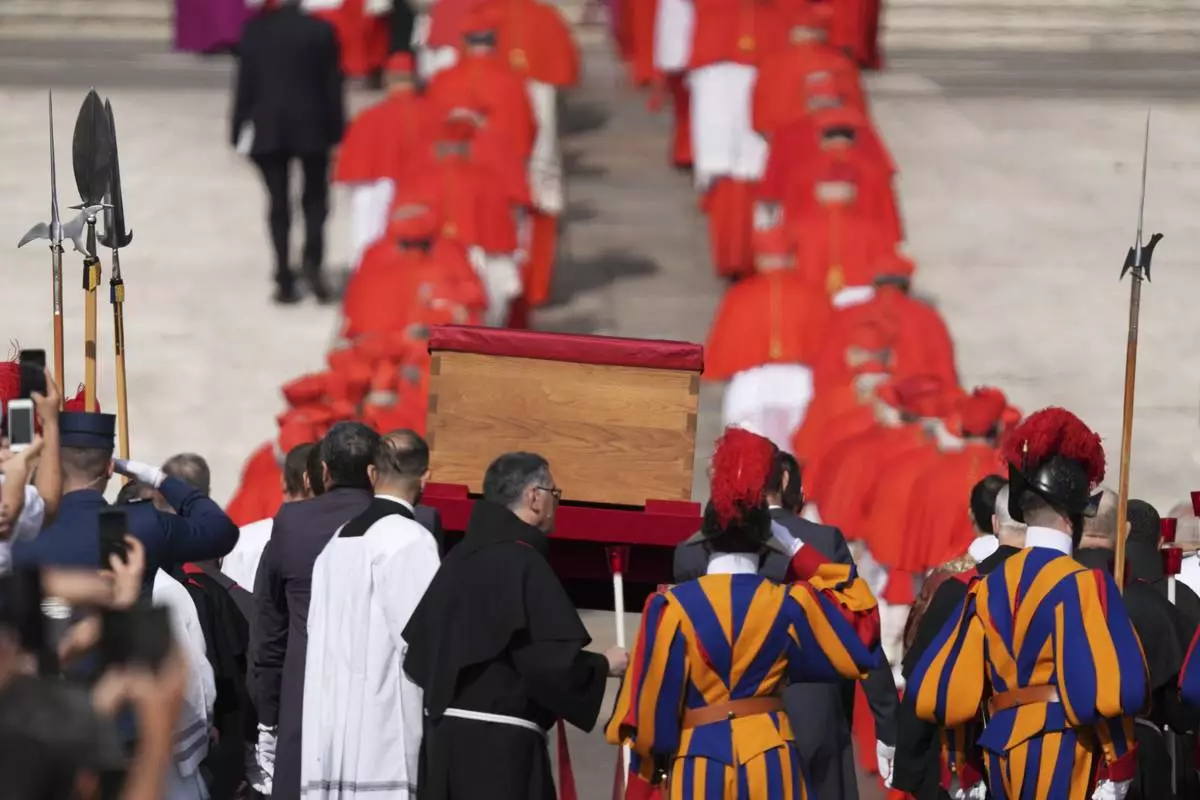 The body of Pope Francis is carried through St. Peter's Square to St. Peter's Basilica at the Vatican, Wednesday, April 23, 2025, where he will lie in state for three days. (AP Photo/Stefano Costantino)
