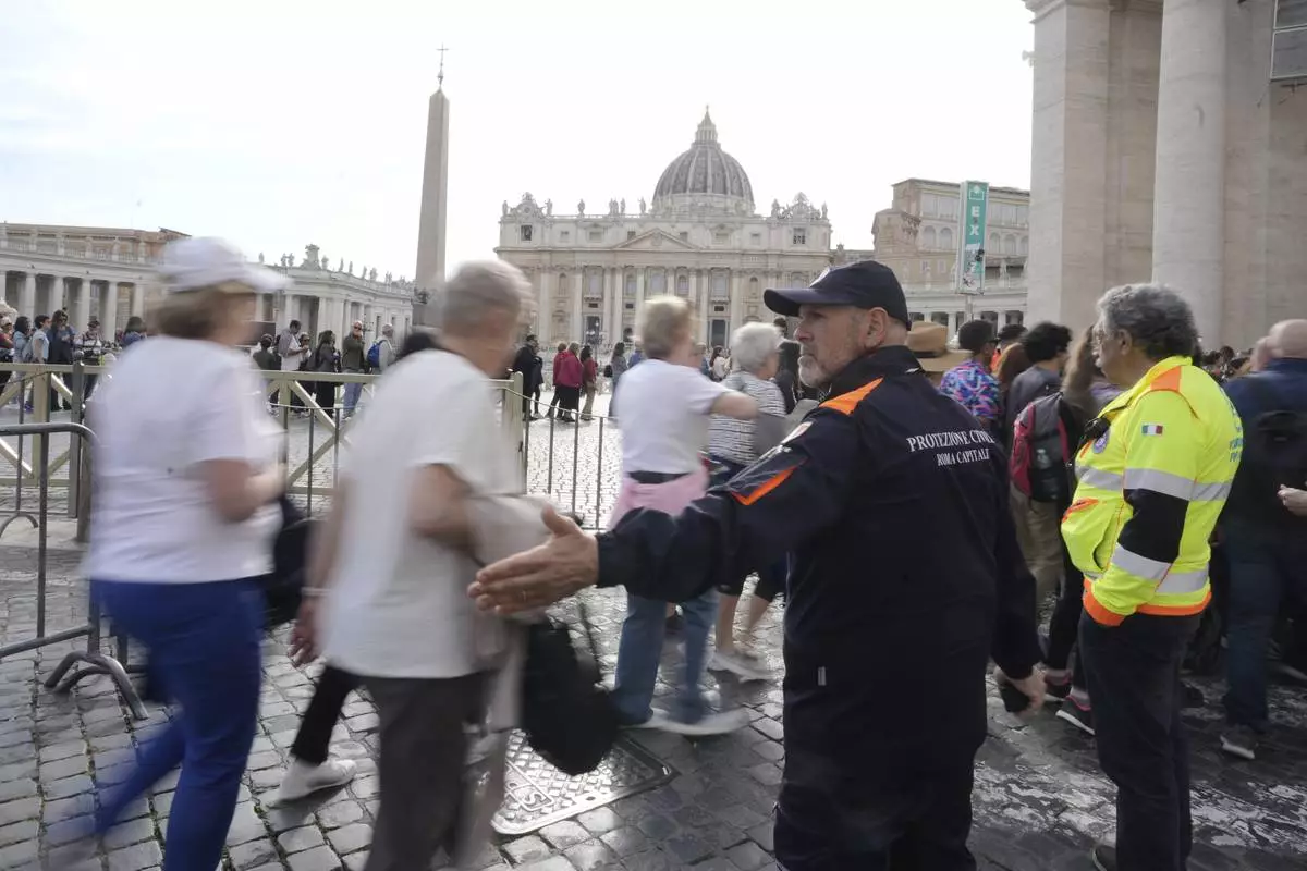 Faithful are channeled in St. Peter's Square at the Vatican, Wednesday, April 23, 2025 as the body of the late Pope Francis will lie in state inside St. Peter's Basilica for three days. (AP Photo/Markus Schreiber)