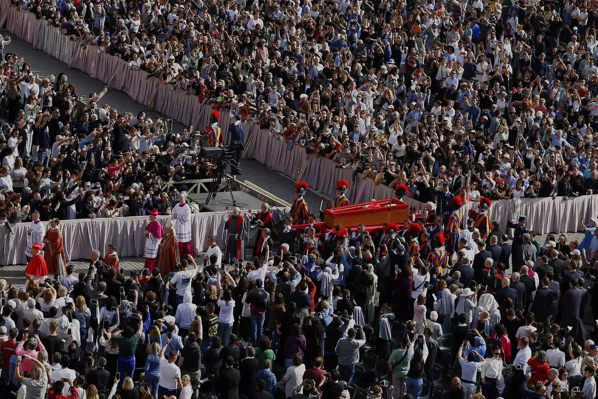 The body of Pope Francis is carried through St. Peter's Square to St. Peter's Basilica at the Vatican, Wednesday, April 23, 2025, where he will lie in state for three days. (Cecilia Fabiano/ Lapresse via AP)