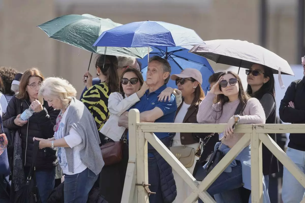 People line up to see the body of Pope Francis is in St. Peter's Basilica at the Vatican, Wednesday, April 23, 2025, where he will lie in state for three days. (AP Photo/Markus Schreiber)