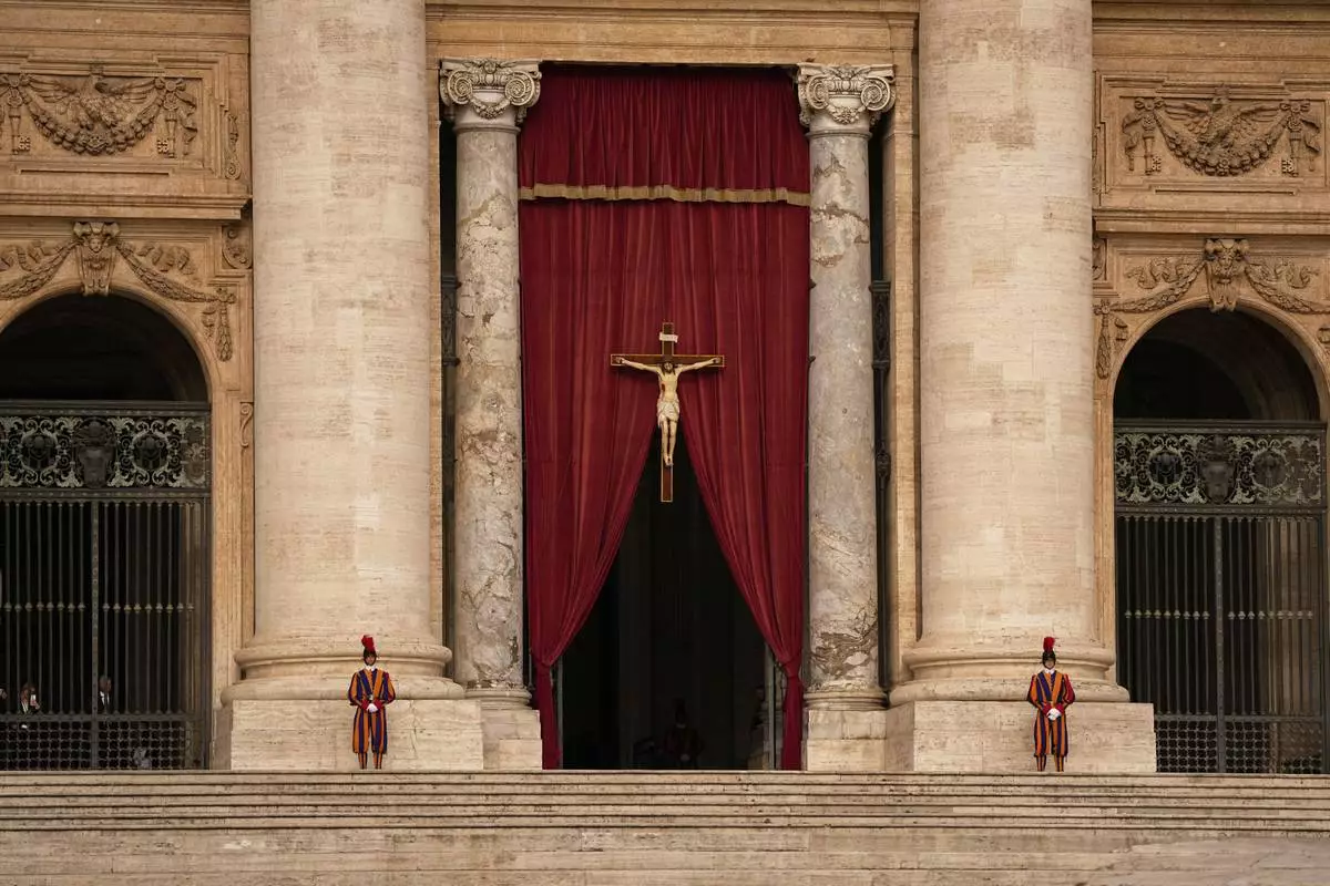 Pontifical Swiss guards stand outside the St. Peter's Basilica, in St. Peter's Square, where the body of Pope Francis will lie in state at for three days, at the Vatican, Wednesday, April 23, 2025. (AP Photo/Andreea Alexandru)