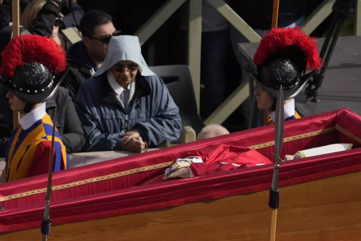 The ceremony with the Pope Francis' body, who will lie in state at St. Peter's Basilica for three days, pass through the crowd at the Vatican, Wednesday, April 23, 2025. (AP Photo/Gregorio Borgia)