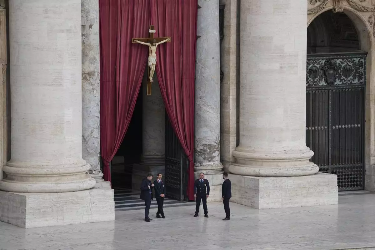 Security persons stand at St. Peter's Square ahead of the arrival of the body of Pope Francis, who will lie in state at St. Peter's Basilica for three days, at the Vatican, Wednesday, April 23, 2025. (AP Photo/Gregorio Borgia)