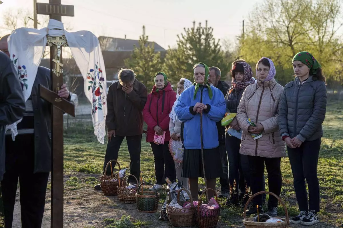People stand in line to have their Easter baskets blessed during celebration of the Orthodox Easter in Krasne village, Ukraine, on Sunday, April 20, 2025. (AP Photo/Evgeniy Maloletka)