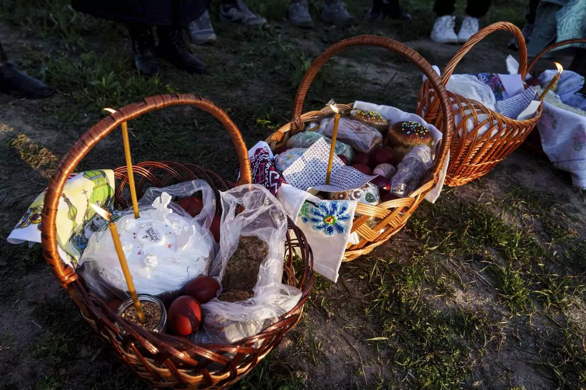 Easter baskets are seen during celebration of the Orthodox Easter in Krasne village, Ukraine, on Sunday, April 20, 2025. (AP Photo/Evgeniy Maloletka)