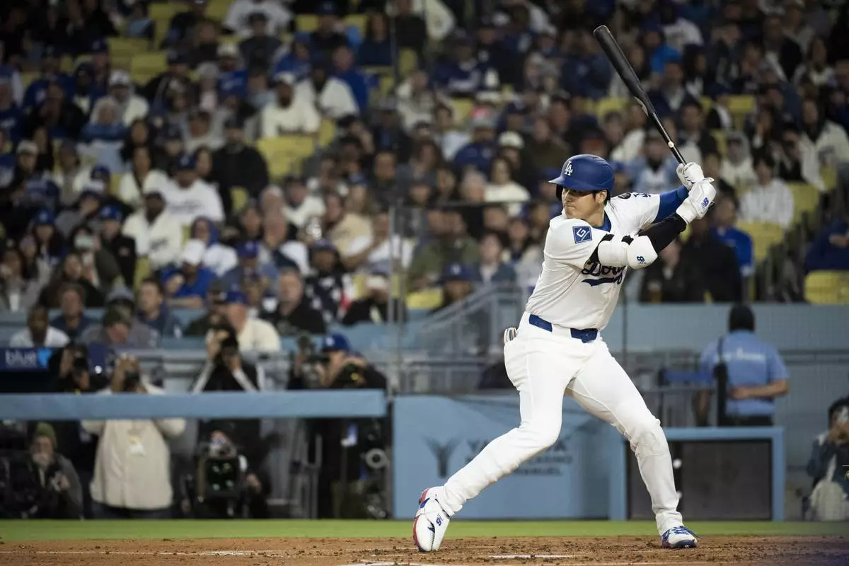 Los Angeles Dodgers' Shohei Ohtani bats during the third inning of a baseball game against the Colorado Rockies in Los Angeles, Tuesday, April 15, 2025. (AP Photo/Kyusung Gong)