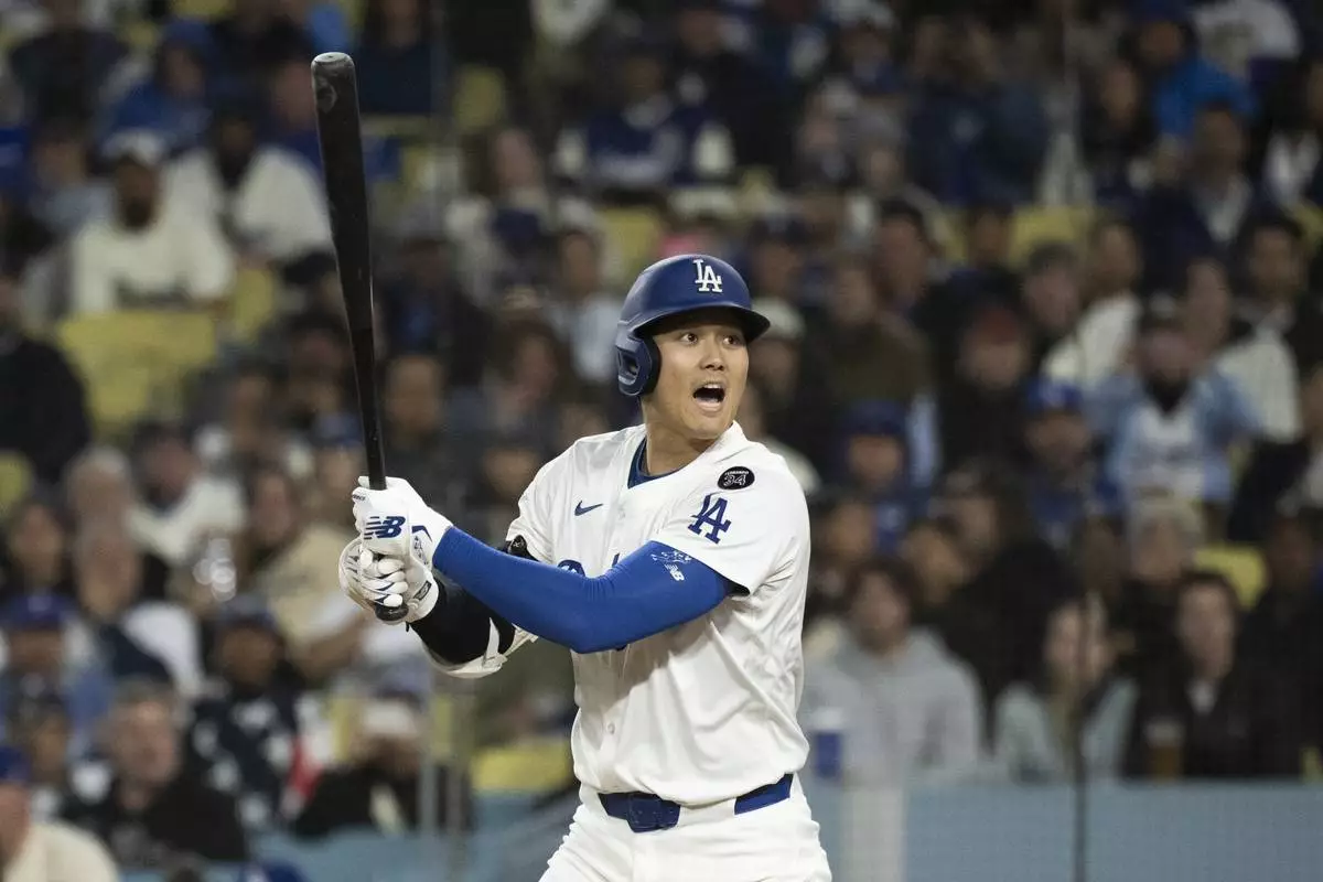 Los Angeles Dodgers' Shohei Ohtani yells after hitting a foul ball towards the stands during the third inning of a baseball game against the Colorado Rockies in Los Angeles, Tuesday, April 15, 2025. (AP Photo/Kyusung Gong)