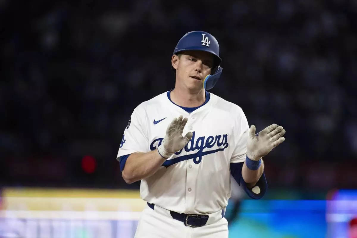Los Angeles Dodgers' Will Smith celebrates after hitting a three-run home run during the third inning of a baseball game against the Colorado Rockies in Los Angeles, Tuesday, April 15, 2025. (AP Photo/Kyusung Gong)