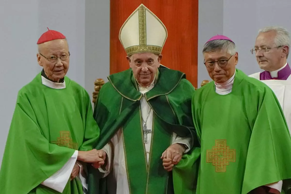 FILE - Pope Francis is joined by Cardinal John Tong Hon, left, and Cardinal-elect Stephen Chow, both from Hong Kong, after presiding over a mass at the Steppe Arena in the Mongolian capital Ulaanbaatar, Sunday, Sept. 3, 2023. (AP Photo/Ng Han Guan, File)
