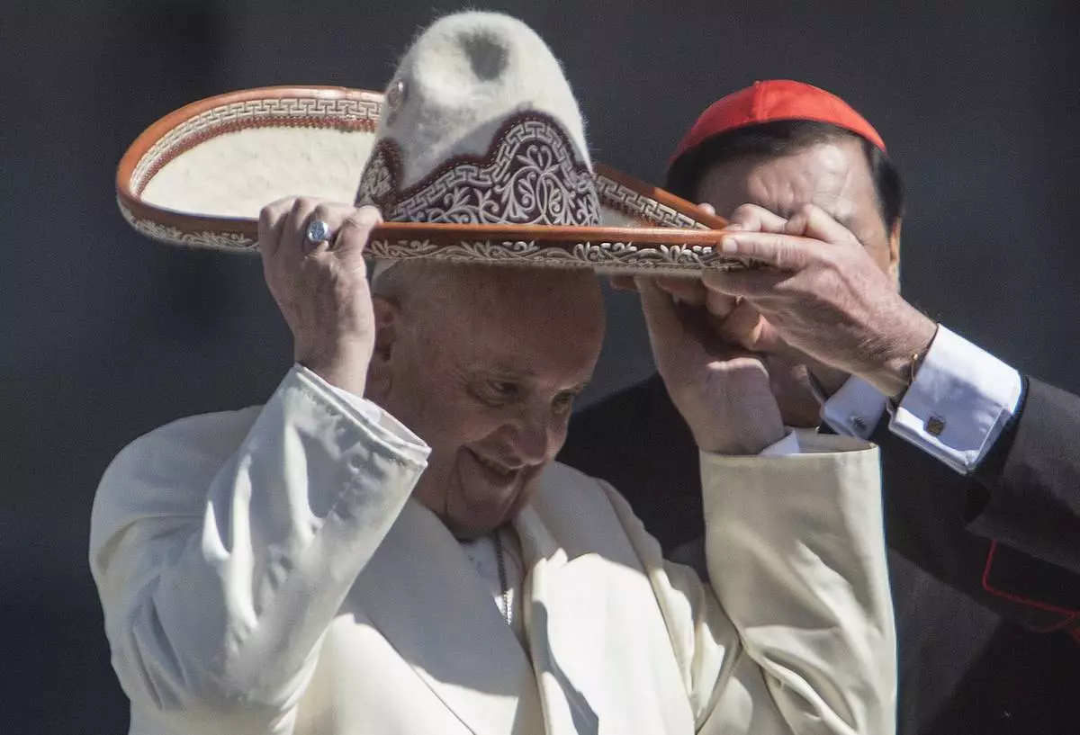 FILE - Pope Francis dons a Mexican charro style sombrero, in Mexico City's main square, the Zocalo, Saturday, Feb. 13, 2016. (AP Photo/Christian Palma, file)