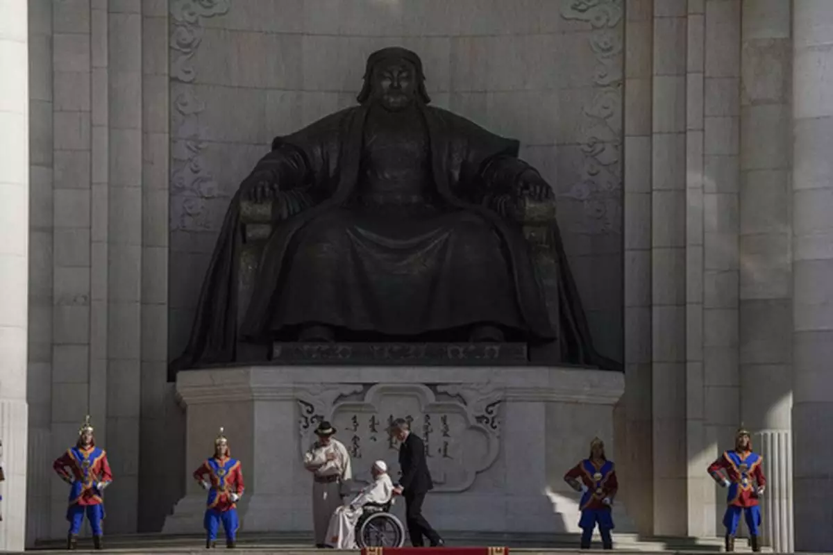 FILE - Mongolian President Ukhnaagiin Khurelsukh, left, and Pope Francis meet in front of a gigantic statue of former Khagan of the Mongol Empire Genghis Khan in Sukhbaatar Square in Ulaanbaatar, Saturday, Sept. 2, 2023. (AP Photo/Ng Han Guan, File)