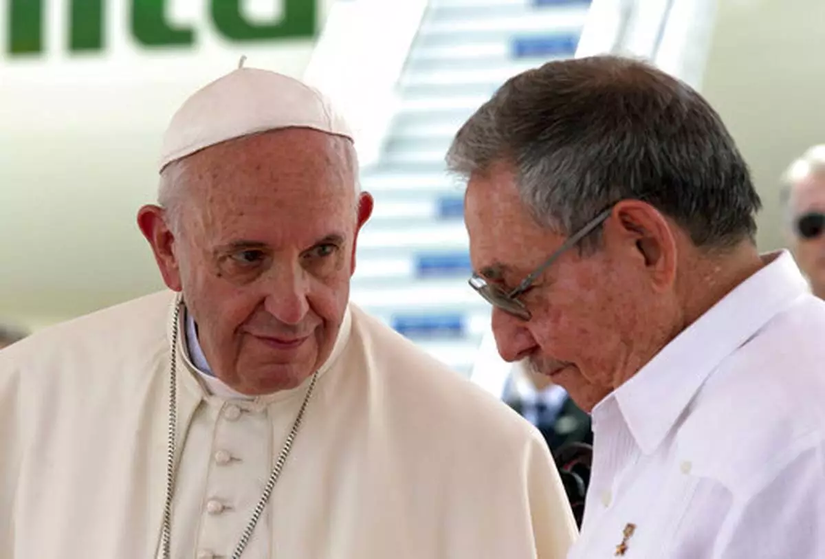 FILE - Pope Francis, left, looks at Cuba's President Raul Castro during his farewell ceremony at the airport in Santiago, Cuba, Tuesday, Sept. 22, 2015. (AP Photo/Enric Marti, file)