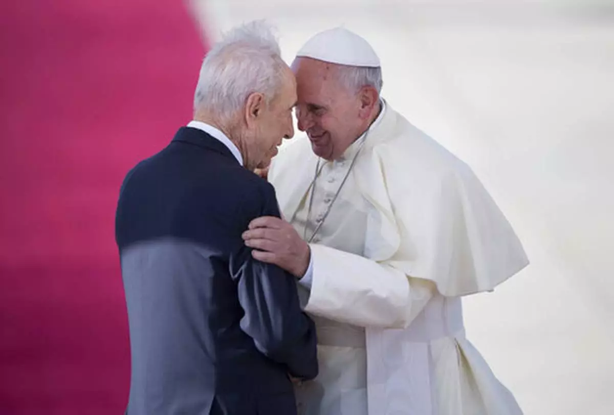 FILE - Pope Francis, right, talks with Israeli President Shimon Peres, during an official arrival ceremony at Ben Gurion airport near Tel Aviv, Israel, Sunday, May 25, 2014. (AP Photo/Oded Balilty, file)