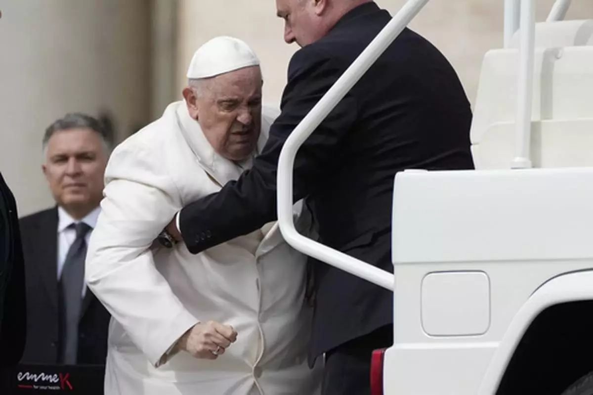 FILE - Pope Francis helped to get on his car at the end of weekly general audience in St. Peter's Square, at the Vatican, Wednesday, March 29, 2023. (AP Photo/Alessandra Tarantino, File)
