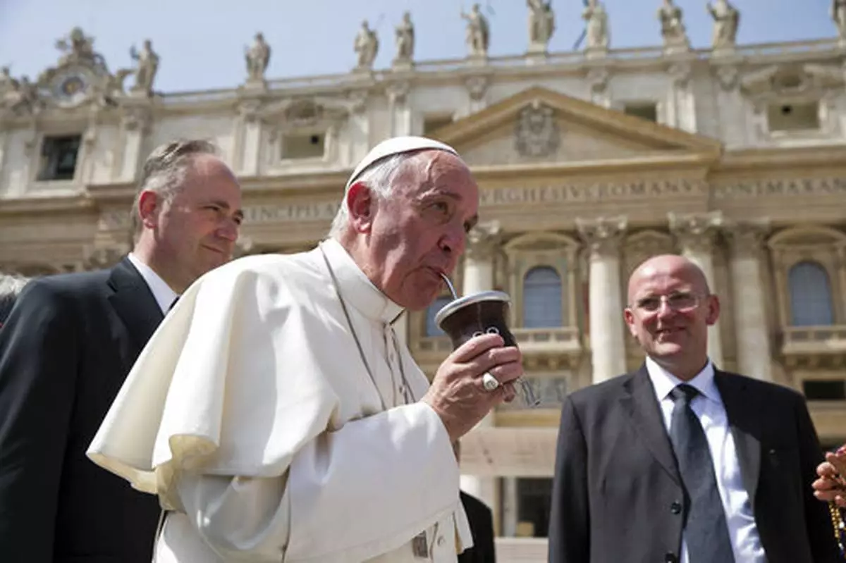 FILE - Pope Francis drinks from a mate gourd, a traditional South American cup, at the end of his weekly general audience, in St. Peter's Square at the Vatican, Wednesday, April 6, 2016. (AP Photo/Andrew Medichini, file)