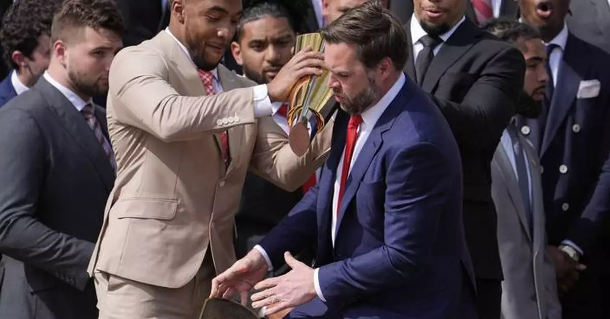 Vance fumbles Ohio State's NCAA football championship trophy as Buckeyes visit the White House