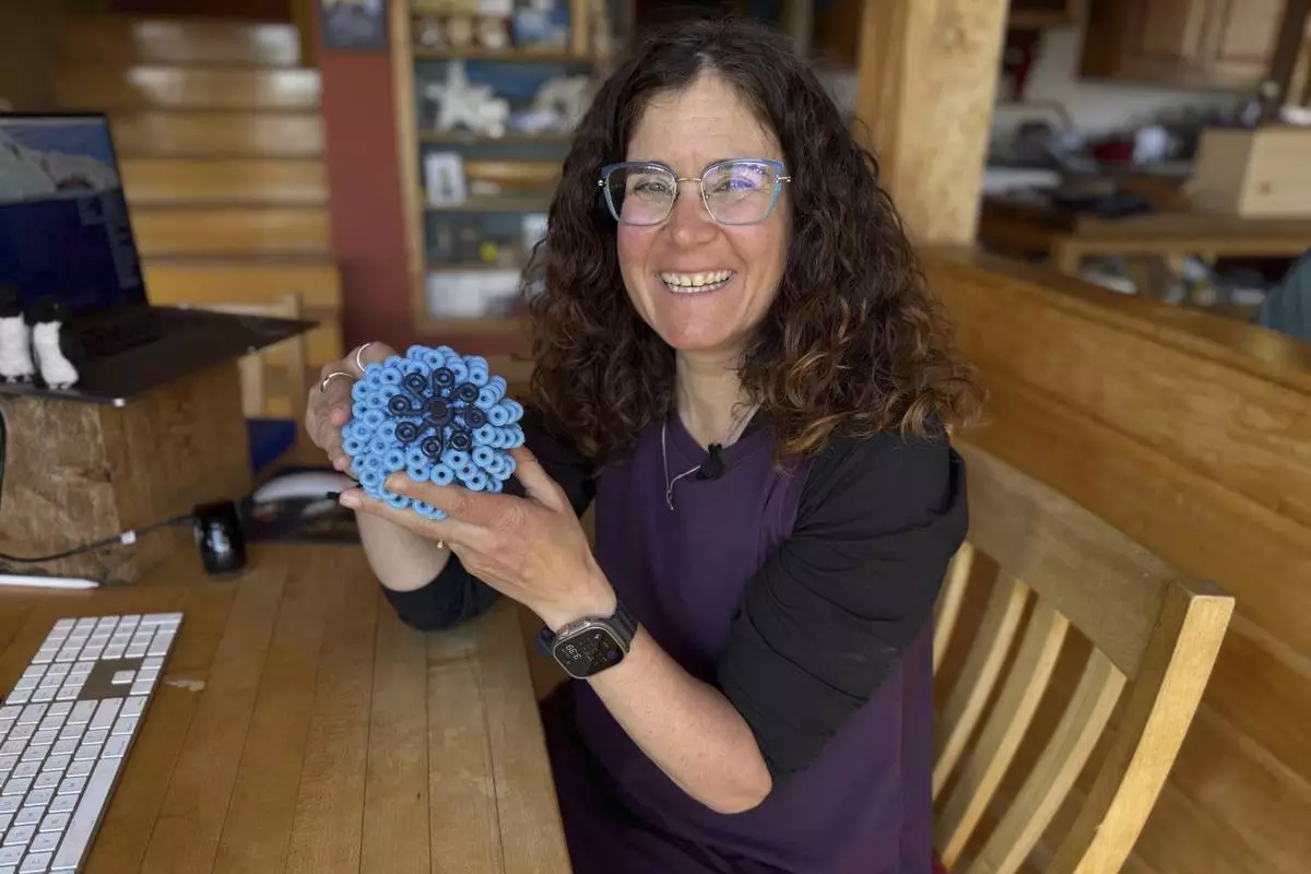 Rachael Z. Miller, founder of the Vermont-based Rozalia Project for a Clean Ocean, displays a Cora Ball, a laundry ball that can be tossed into the washer to cut down on clothes banging into each other and also catches microfibers, on Thursday, April 17, 2025, in Granville, Vt. (AP Photo/Amanda Swinhart)