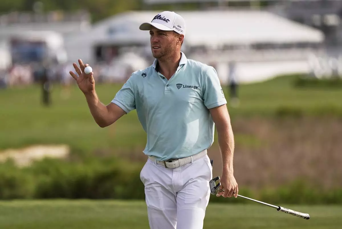 Justin Thomas waves to the gallery after making a putt on the 18th hole during the final round of the RBC Heritage golf tournament, Sunday, April 20, 2025, in Hilton Head Island, S.C. (AP Photo/Mike Stewart)