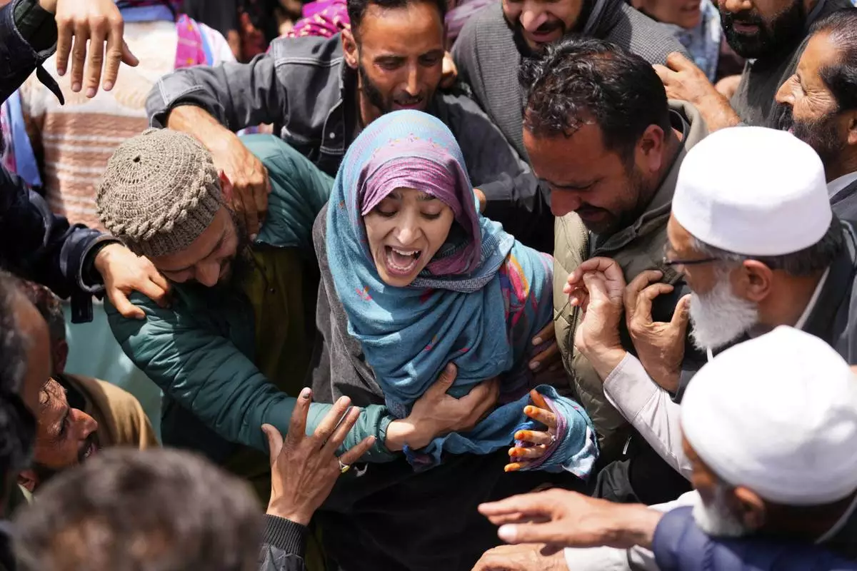 A relative wails during the funeral procession of Adil Hussain Shah, a daily-wage worker, who died when militants indiscriminately opened fire on a crowd of mainly tourists on Tuesday, at his village Hapatnar, about 20 km (13 miles) from Pahalgam where the incident took place, Indian controlled Kashmir, Wednesday, April 23, 2025. (AP Photo/Dar Yasin)