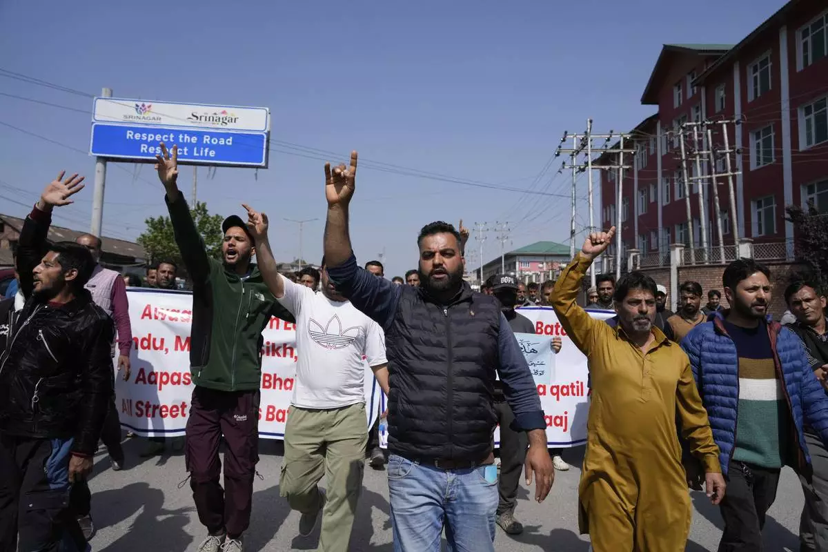 Kashmiri men shout slogans during a protest after tourists were killed in Srinagar, Indian controlled Kashmir, Wednesday, April. 23, 2025. (AP Photo/Mukhtar Khan)