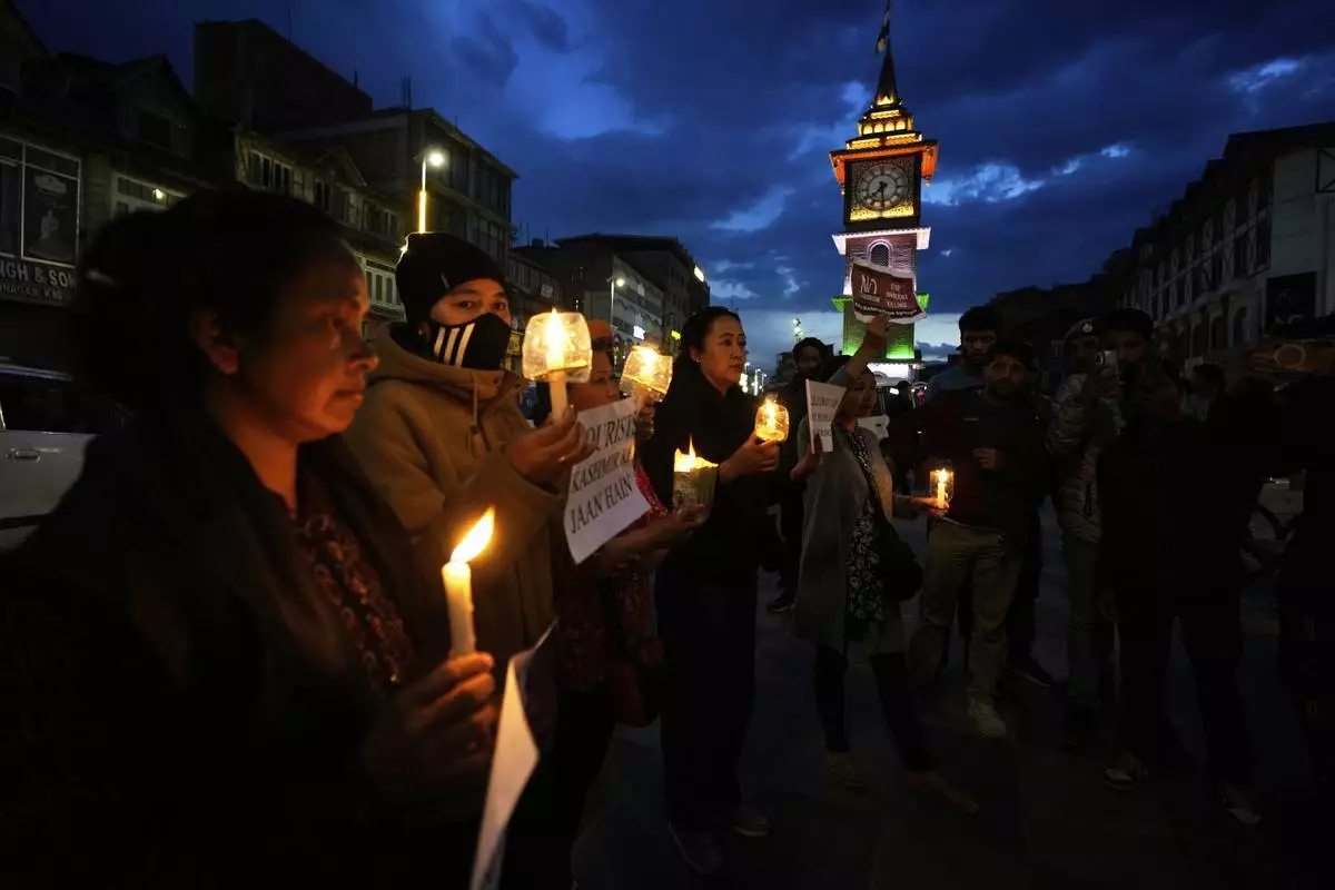 People hold candles during a candlelight protest in Srinagar, Indian controlled Kashmir, Wednesday, April 23, 2025, a day after an attack killed at least 26 people, most of them tourists. (AP Photo/Mukhtar Khan)