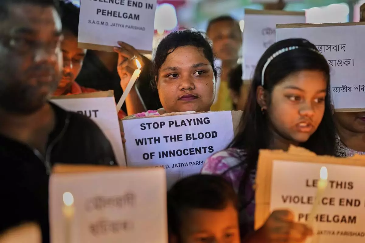 People protest against the killing of tourists by militants a day after militants indiscriminately opened fire on tourists near Pahalgam in Indian controlled Kashmir, in Guwahati, India, Wednesday, April 23, 2025. (AP Photo/Anupam Nath)