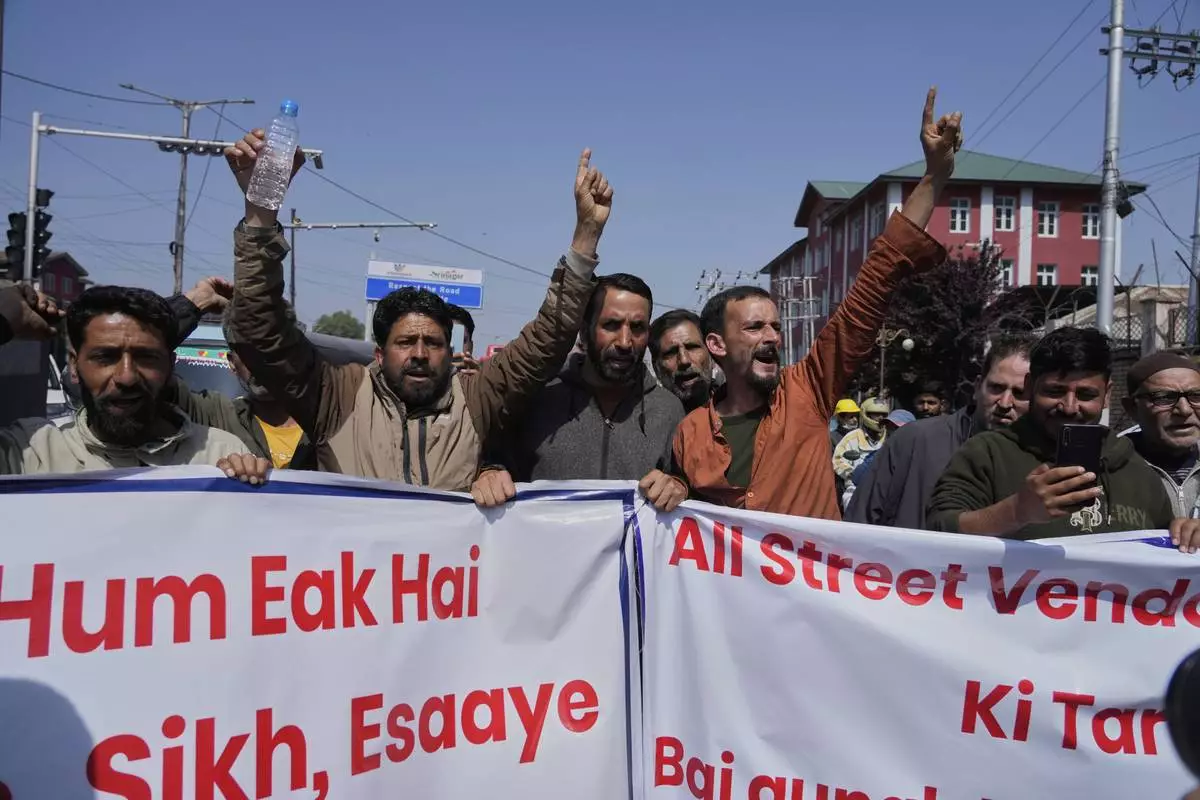 Kashmiri men shout slogans during a protest after tourists were killed in Srinagar, Indian controlled Kashmir, Wednesday, April. 23, 2025. (AP Photo/Mukhtar Khan)