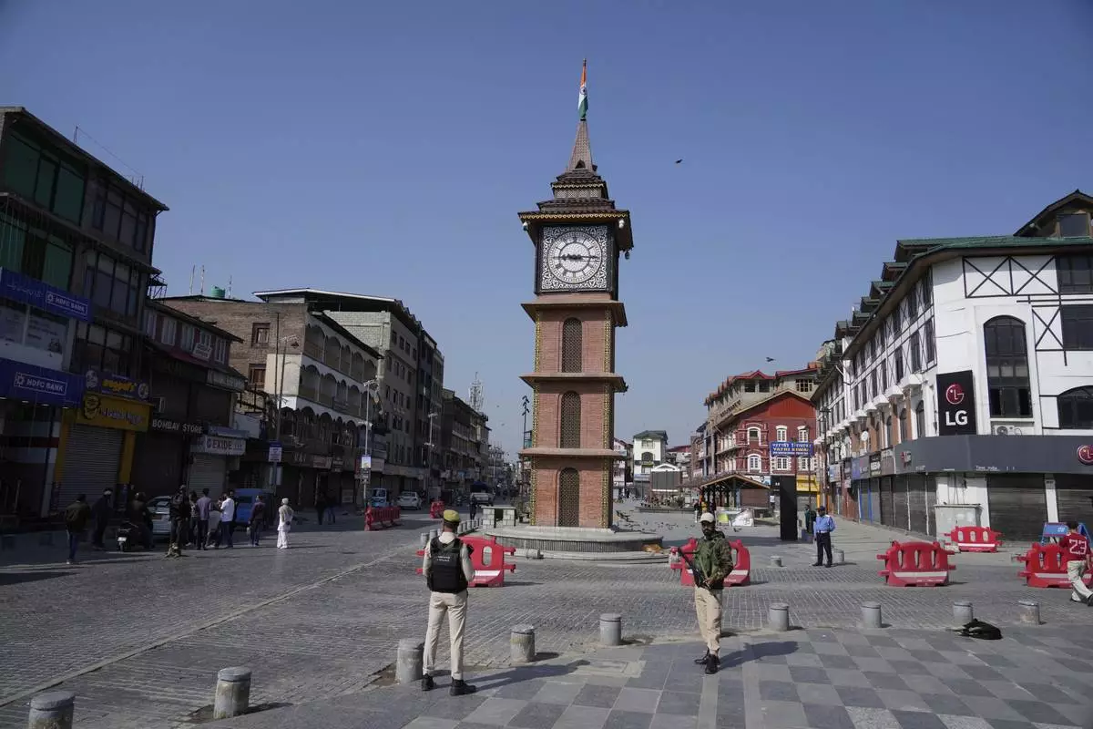 Indian policemen guard in the city centre during a shut down after tourists were killed, in Srinagar, Indian controlled Kashmir, Wednesday, April. 23, 2025. (AP Photo/Mukhtar Khan)