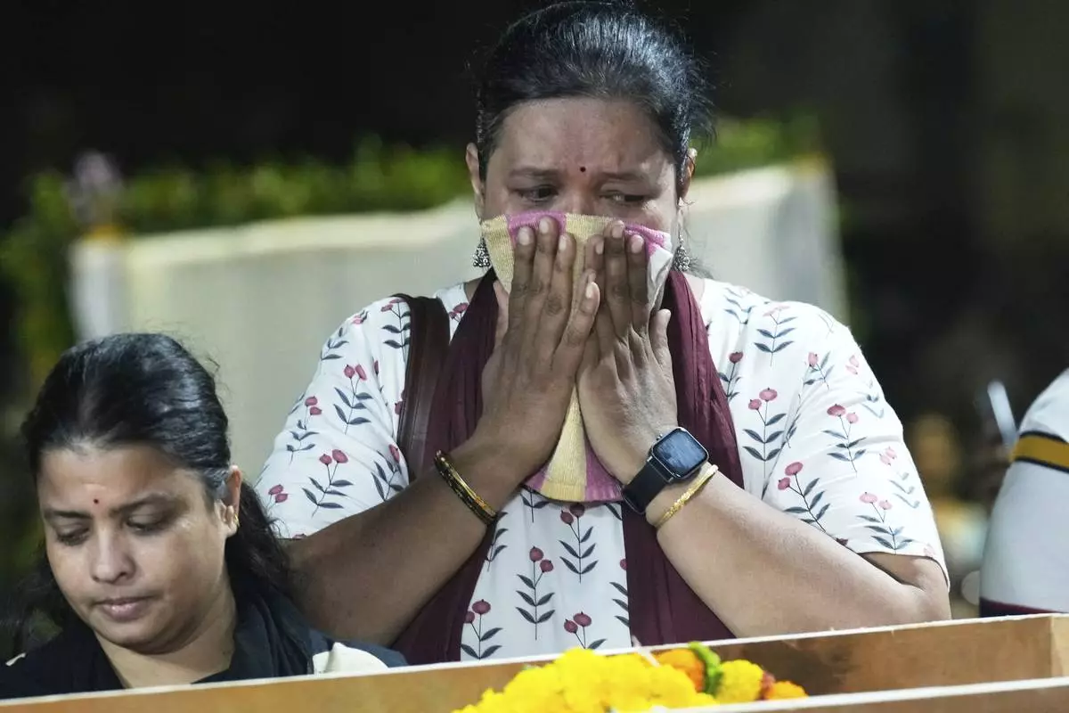 A relative of Hemant Joshi, who was a victim in a deadly attack on tourists in the Pahalgam region of Indian-administered Kashmir, reacts at Dombivali near Mumbai, India, Wednesday, April. 23, 2025.(AP Photo/Rajanish Kakade)