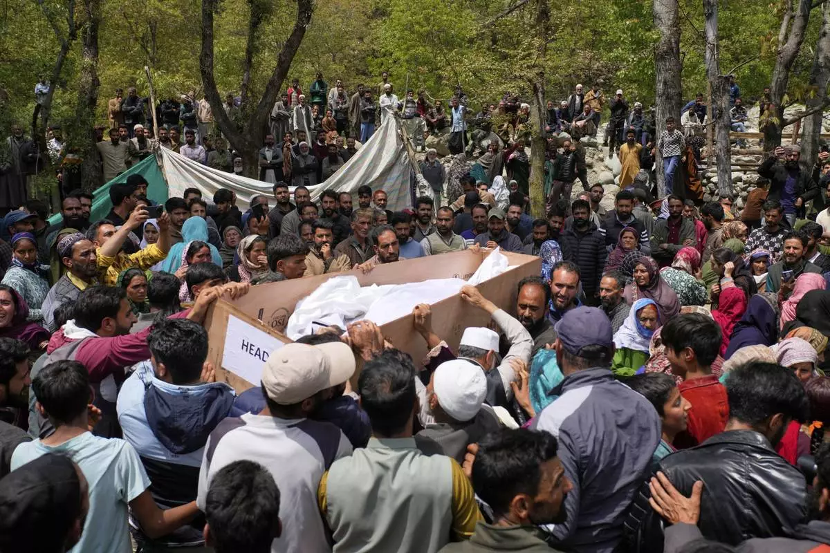 The body of Adil Hussain Shah, a daily-wage worker, who was killed when militants indiscriminately opened fire on a crowd of mainly tourists on Tuesday, is carried for burial at his village Hapatnar, about 20 km (13 miles) from Pahalgam where the incident took place, Indian controlled Kashmir, Wednesday, April 23, 2025. (AP Photo/Dar Yasin)