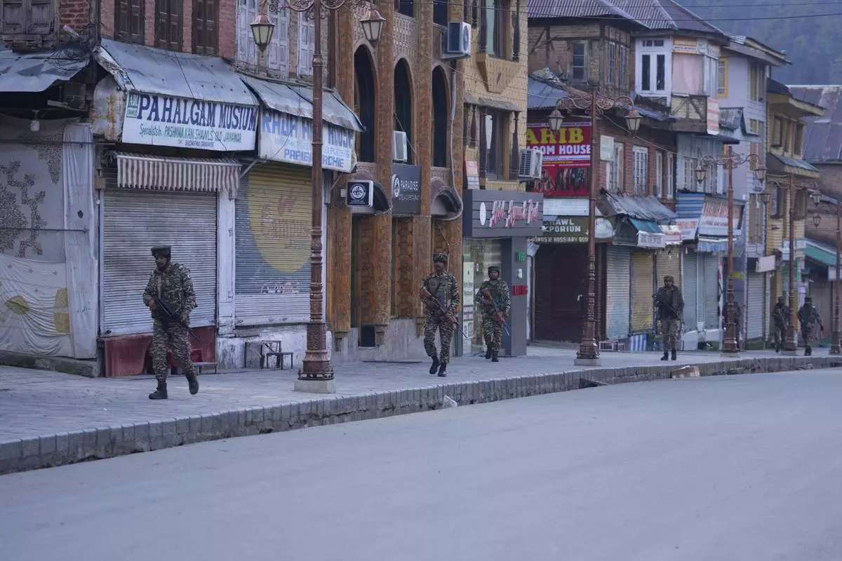 Indian security officers patrol a shopping area in Pahalgam a day after militants indiscriminately opened fire on tourists near the town, Indian controlled Kashmir, Wednesday, April 23, 2025. (AP Photo/Dar Yasin)