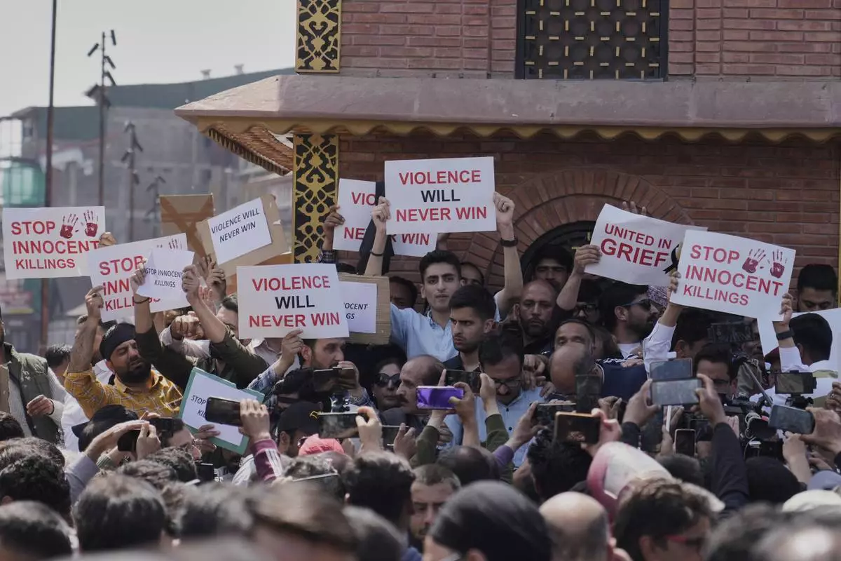 Jammu and Kashmir National Conference (JKNC) members attend a protest after tourists were killed, in Srinagar, Indian controlled Kashmir, Wednesday, April. 23, 2025. (AP Photo/Mukhtar Khan)