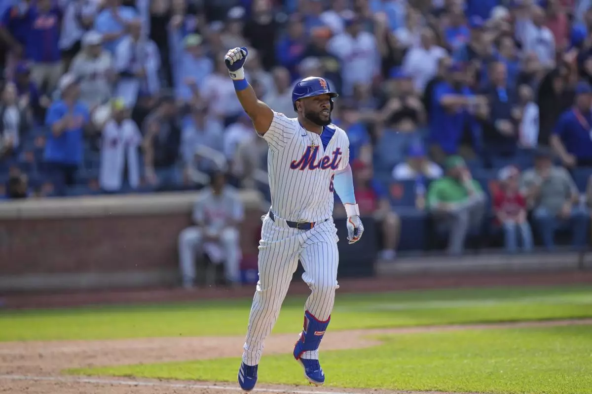 New York Mets' Starling Marte reacts after hitting a walk-off single during the tenth inning of a baseball game against the Philadelphia Phillies, Wednesday, April 23, 2025, in New York. (AP Photo/Seth Wenig)