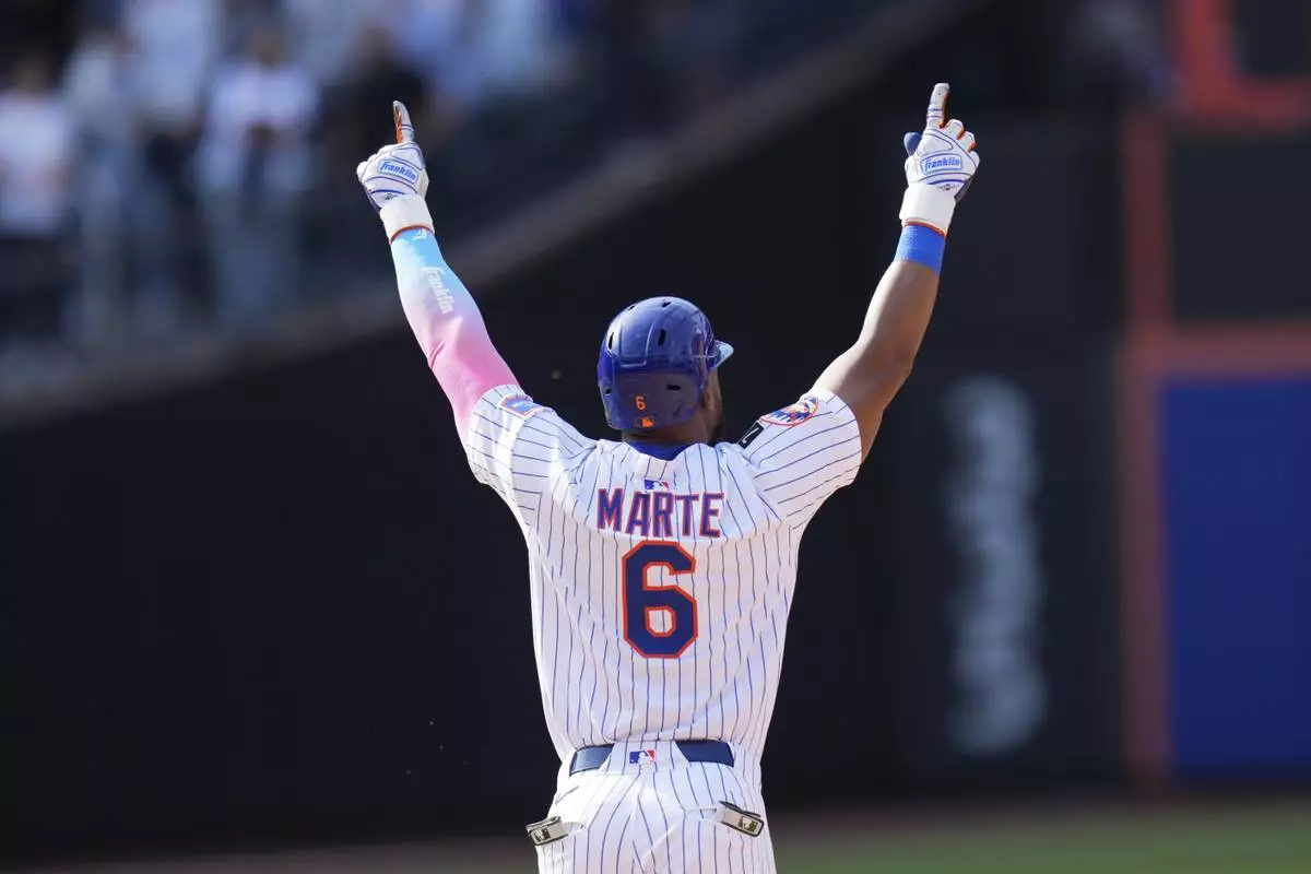 New York Mets' Starling Marte reacts after hitting a walk-off single during the tenth inning of a baseball game against the Philadelphia Phillies, Wednesday, April 23, 2025, in New York. (AP Photo/Seth Wenig)
