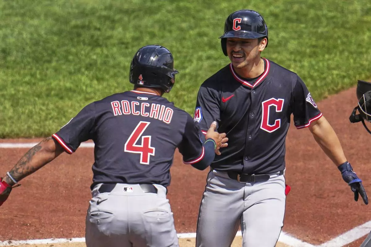 Cleveland Guardians' Steven Kwan, right, is greeted by Brayan Rocchio after both scored on Kwan's two-run home run off Pittsburgh Pirates pitcher Mitch Keller, not pictured, during the third inning of a baseball game in Pittsburgh, Sunday, April 20, 2025. (AP Photo/Gene J. Puskar)