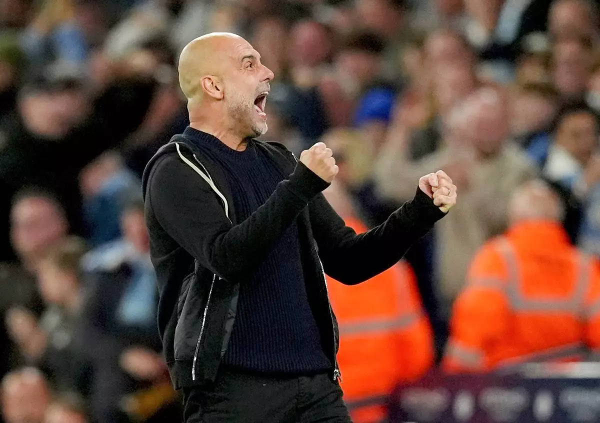 Manchester City manager Pep Guardiola celebrates their side's second goal of the game during a Premier League soccer match between Manchester City and Aston Villa, Tuesday, April 22, 2025, at the Etihad Stadium in Manchester, England. (Martin Rickett/PA via AP)