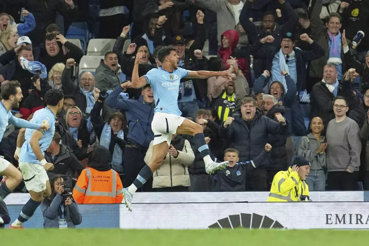 Manchester City's Matheus Nunes celebrates after scoring his side's second goal during the English Premier League soccer match between Manchester City and Aston Villa at Etihad stadium in Manchester, England, Tuesday, April 22, 2025. (AP Photo/Jon Super)
